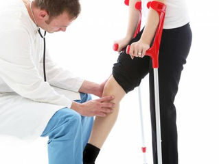 Doctor checking patient's ACL injury