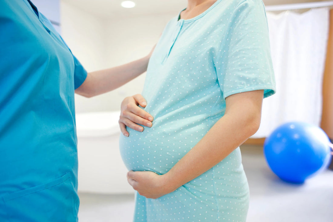 Pregnant woman holding her belly