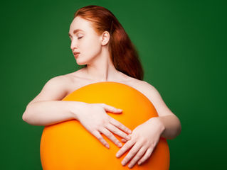 Woman hugging an orange pillow