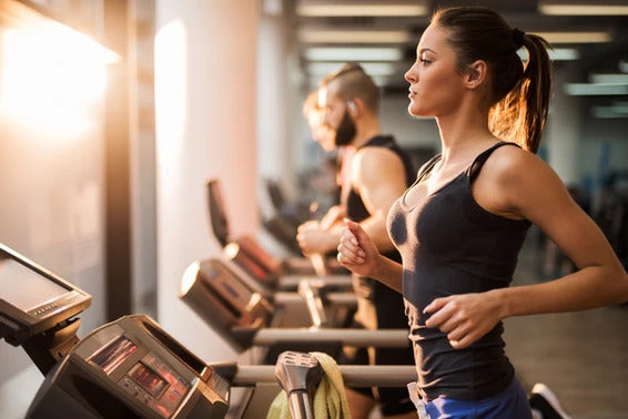 Woman running on treadmill to exercise more efficiently
